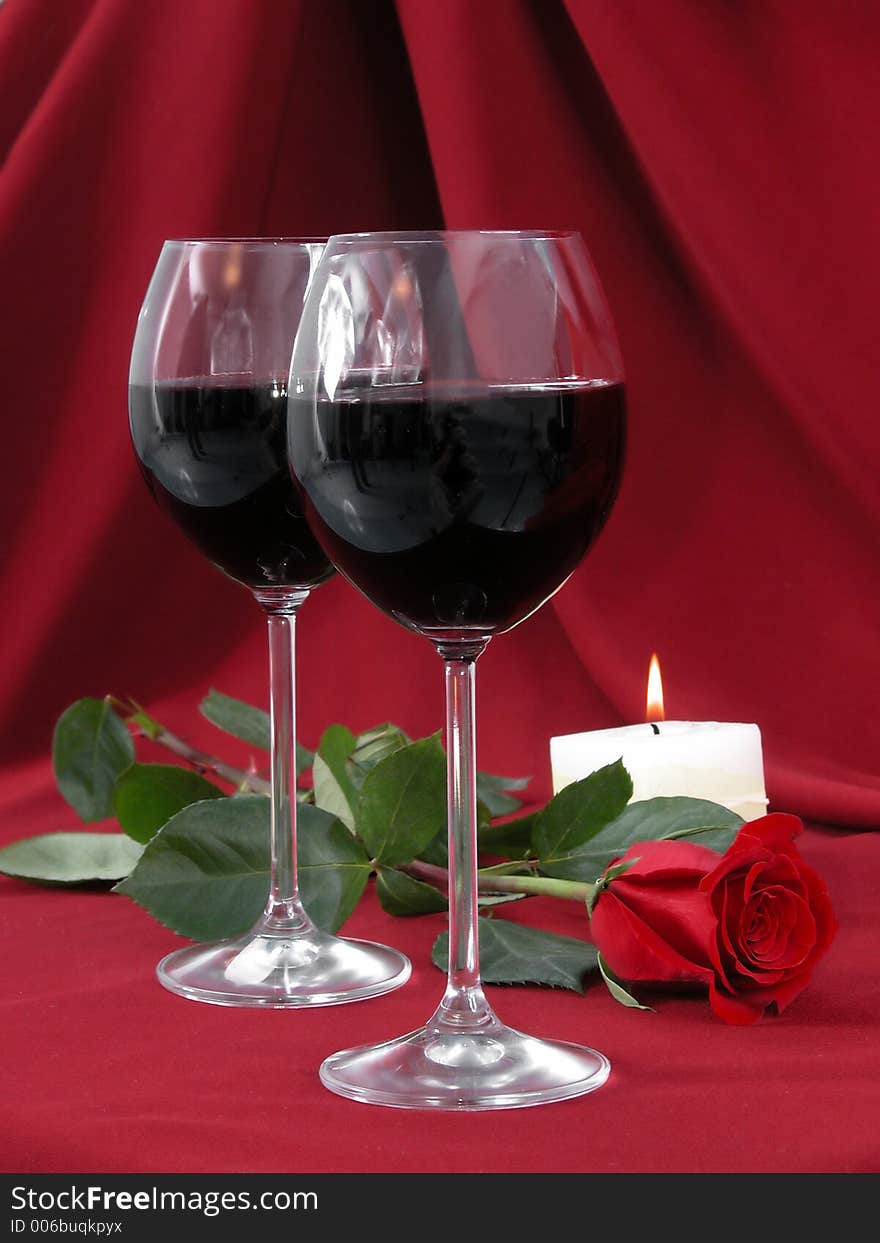 Wineglasses, rose and burning candle. Wineglasses, rose and burning candle