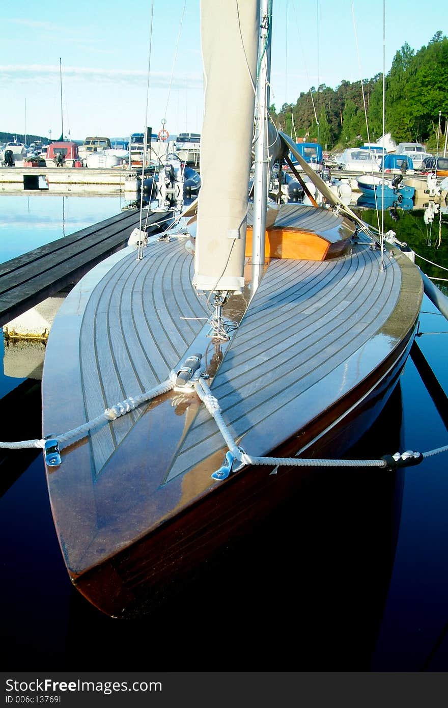 Classic wooden sailboat with teak-deck at a yacht harbour