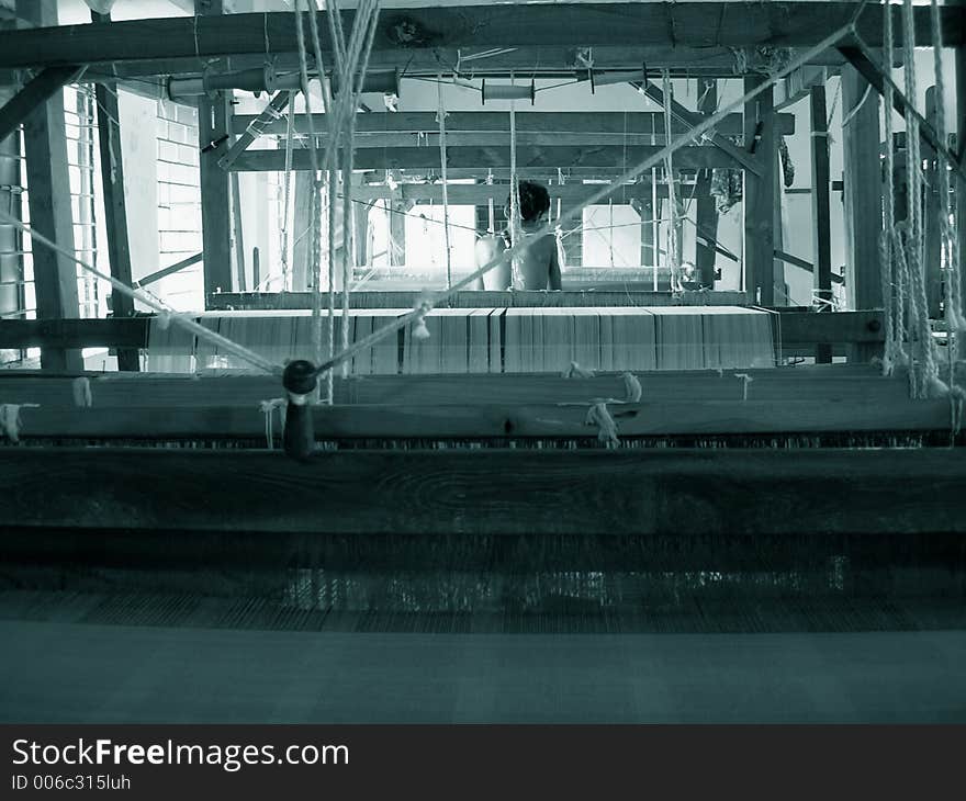 Man working on a handloom. Man working on a handloom