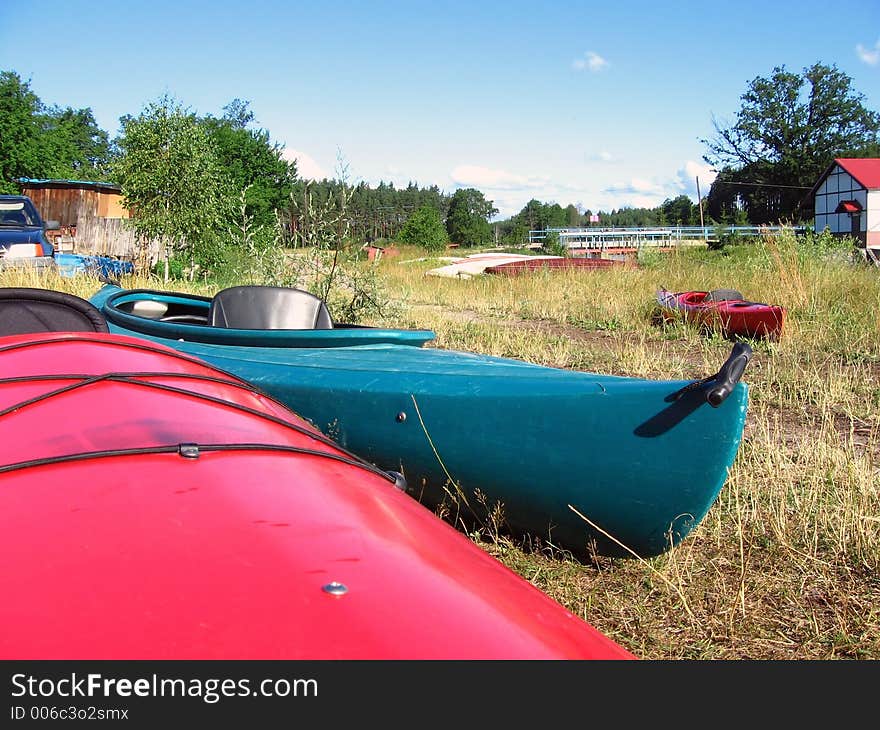 Canoes wait on the river bank. Canoes wait on the river bank