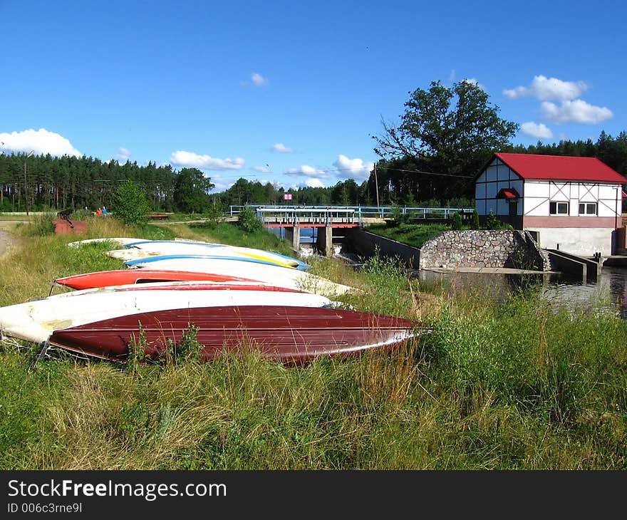 Canoes wait on the river bank. Canoes wait on the river bank