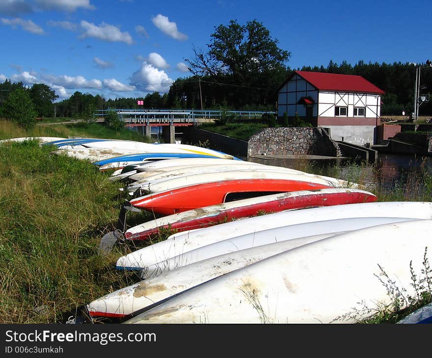 Canoes wait on the river bank. Canoes wait on the river bank