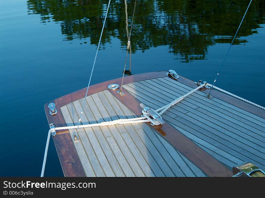 Rear end of classic, wooden sailboat with teak-deck. Rear end of classic, wooden sailboat with teak-deck