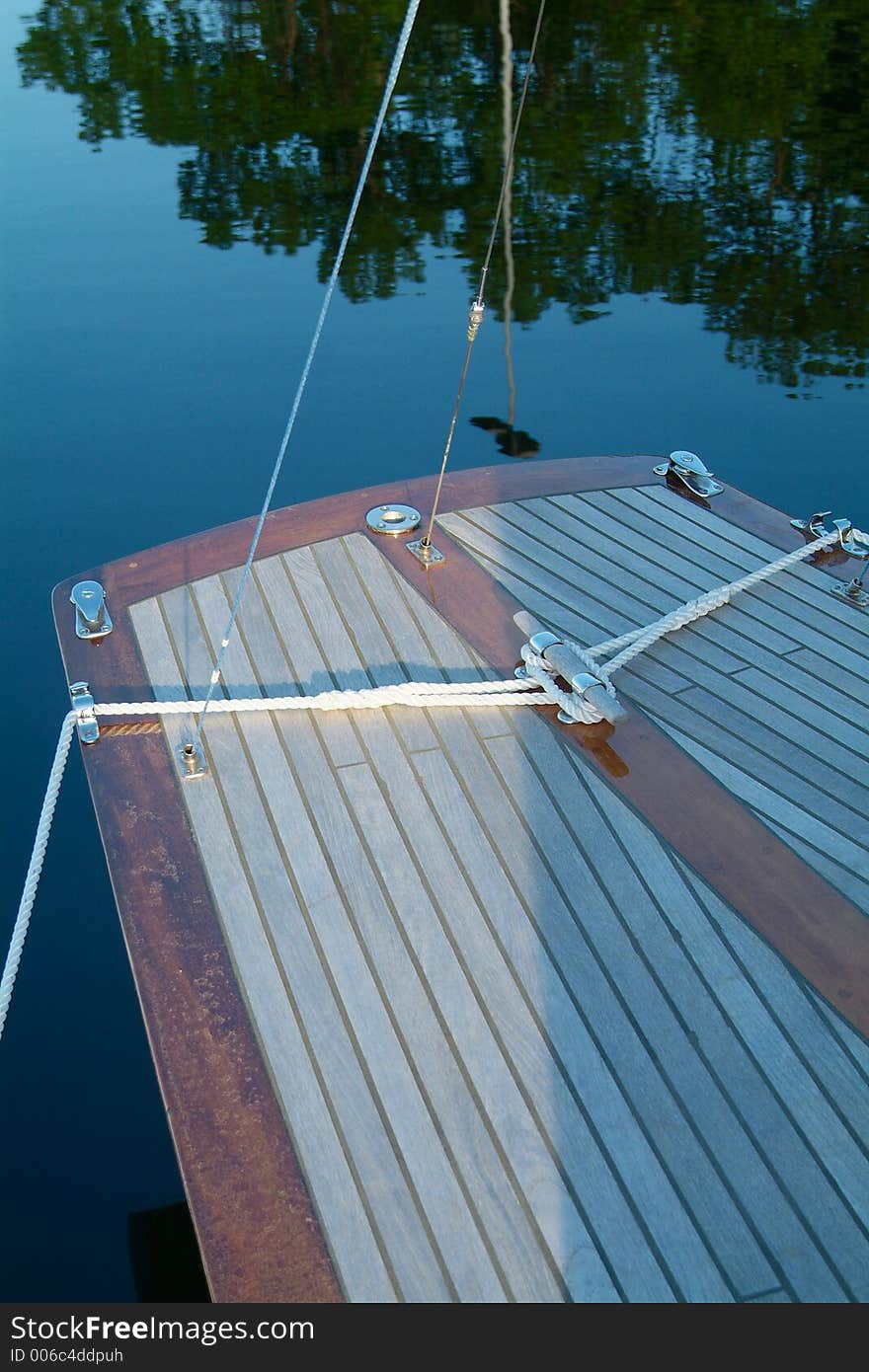 Rear end of classic, wooden sailboat with teak-deck. Rear end of classic, wooden sailboat with teak-deck