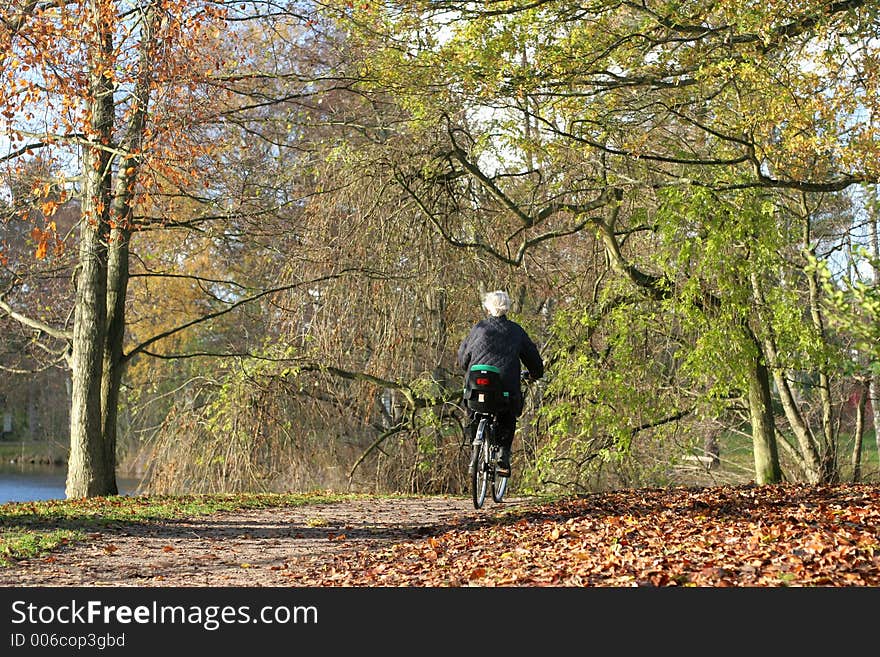 Lady on a cycle in autumn in the countryside  in denmark. Lady on a cycle in autumn in the countryside  in denmark