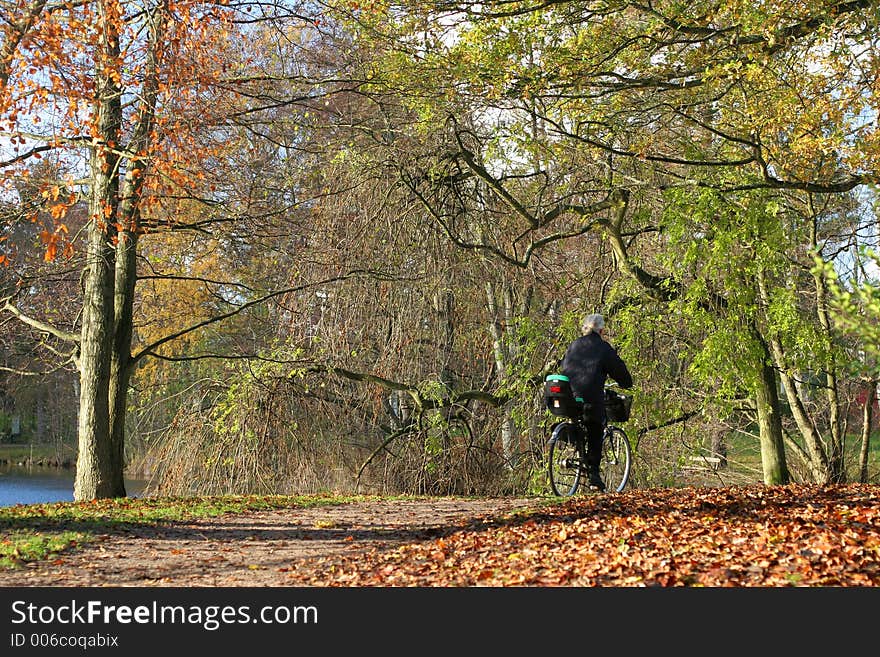 Lady on a cycle in autumn in the countryside  in denmark. Lady on a cycle in autumn in the countryside  in denmark