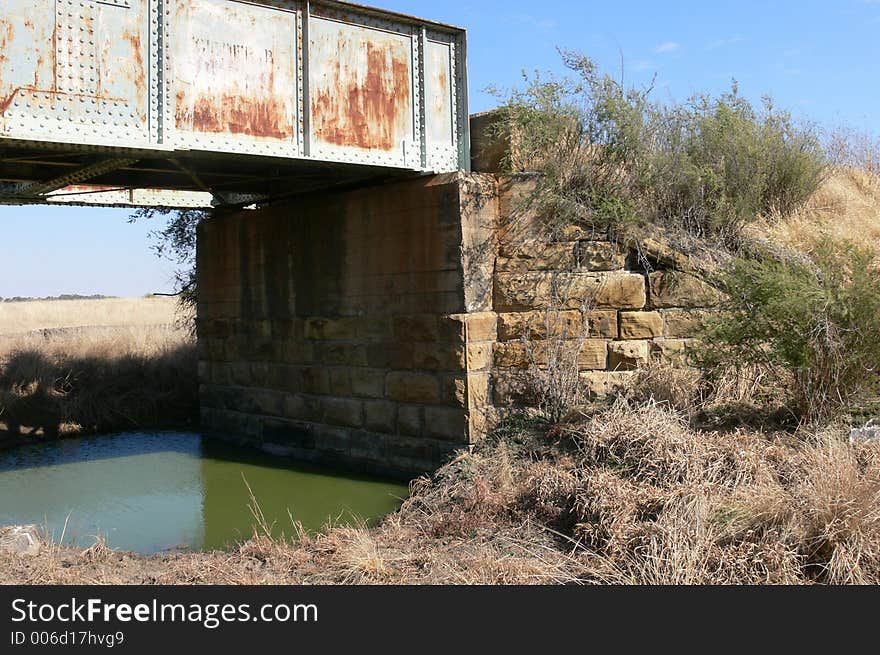 Steel railroad bridge build onto sandstone