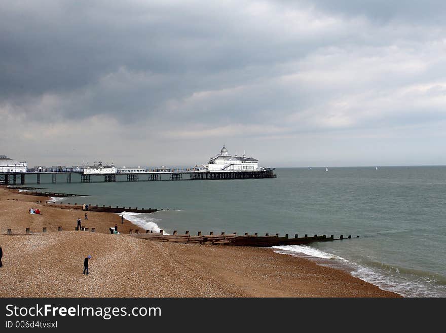 The stony beach separated by the groins by the Eastbourne pier. The stony beach separated by the groins by the Eastbourne pier