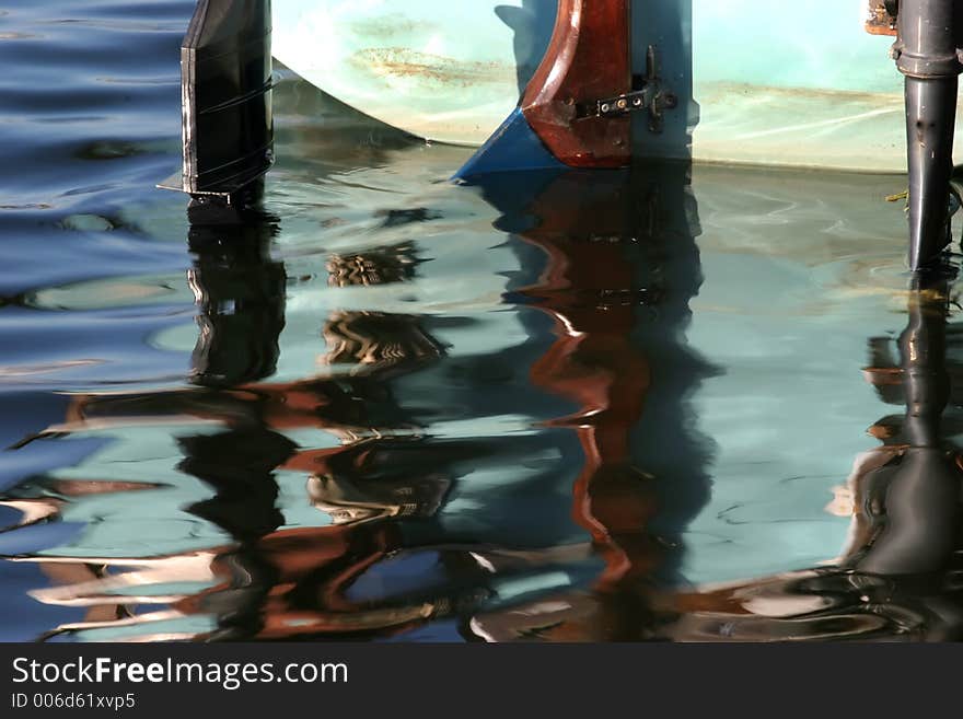 Vivid reflections of the rear end of a motor boat. Engines and tiler. Vivid reflections of the rear end of a motor boat. Engines and tiler.