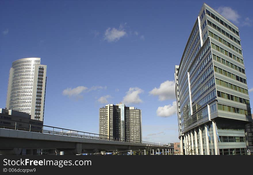 A picture of a cople of futuristic office buildings, with a blue sky as back ground. A picture of a cople of futuristic office buildings, with a blue sky as back ground.