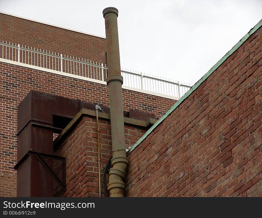 Boston Roof Top with smoke stack, showing brick walls, railings, and duct work. Boston Roof Top with smoke stack, showing brick walls, railings, and duct work