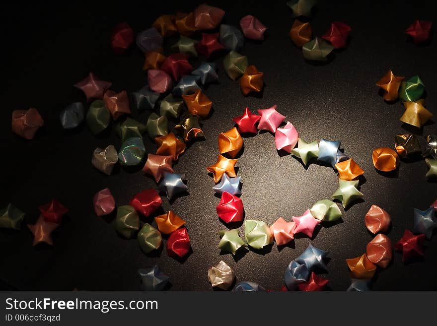 Origami stars spotlighted on a black surface. Origami stars spotlighted on a black surface