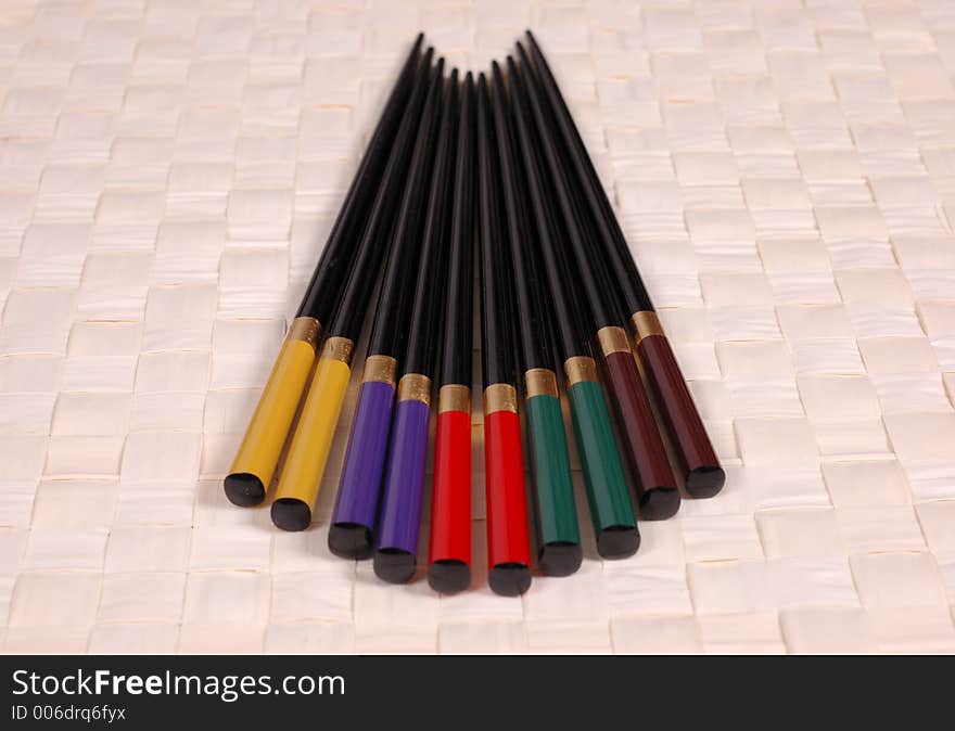 Multi colored chop sticks on mat