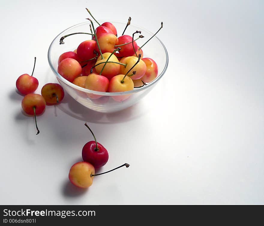 Clear glass bowl full of Ranier cherries. Clear glass bowl full of Ranier cherries