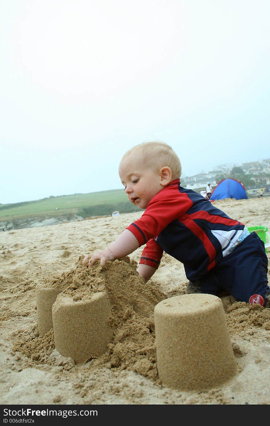 Small child exploring a beach in Cornwall. Small child exploring a beach in Cornwall.