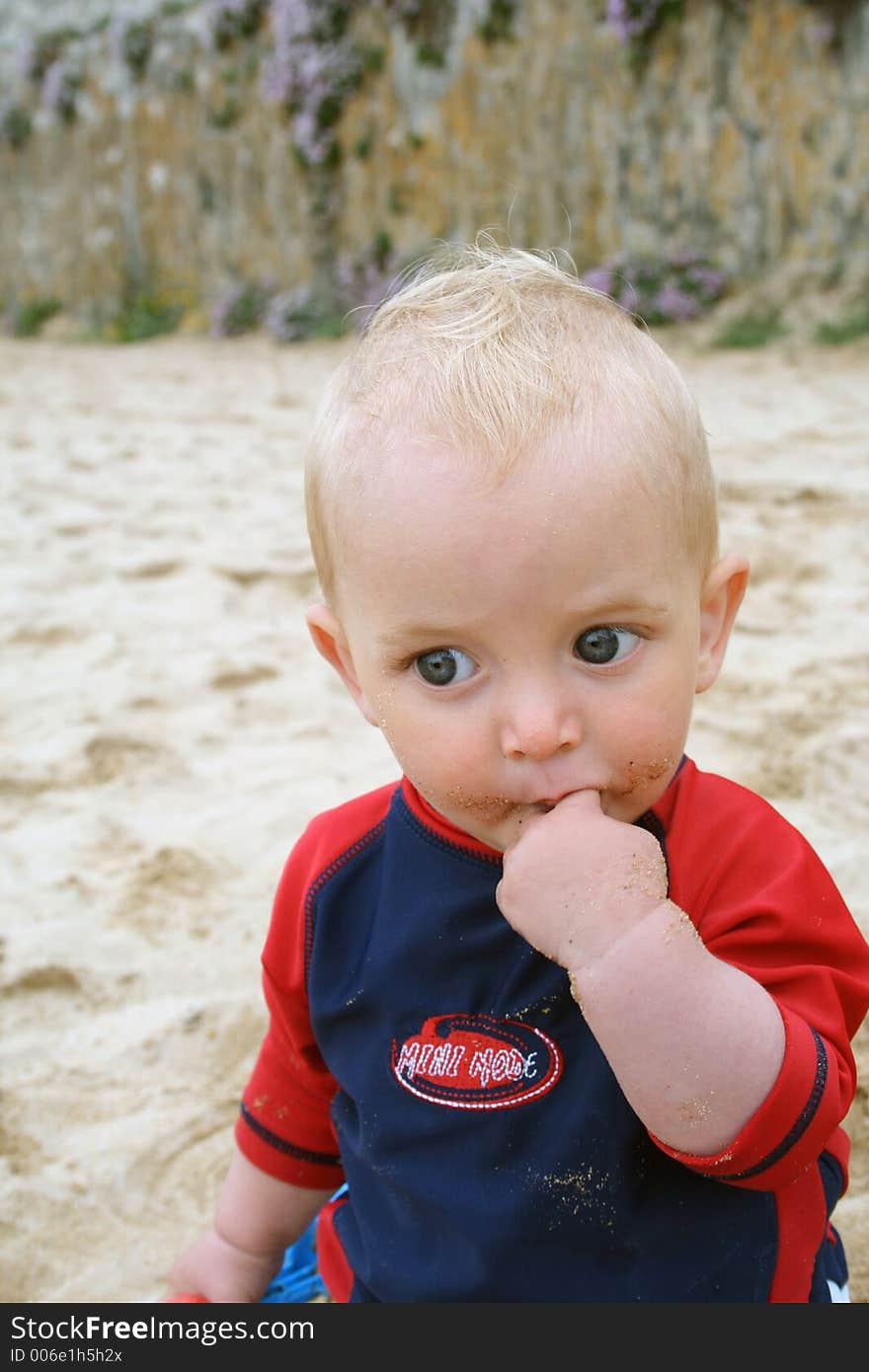 Small child exploring a beach in Cornwall. Small child exploring a beach in Cornwall.