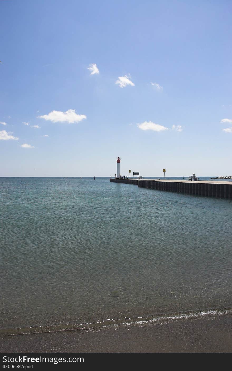 Clear beach water by lighthouse at Whitby, Ontario