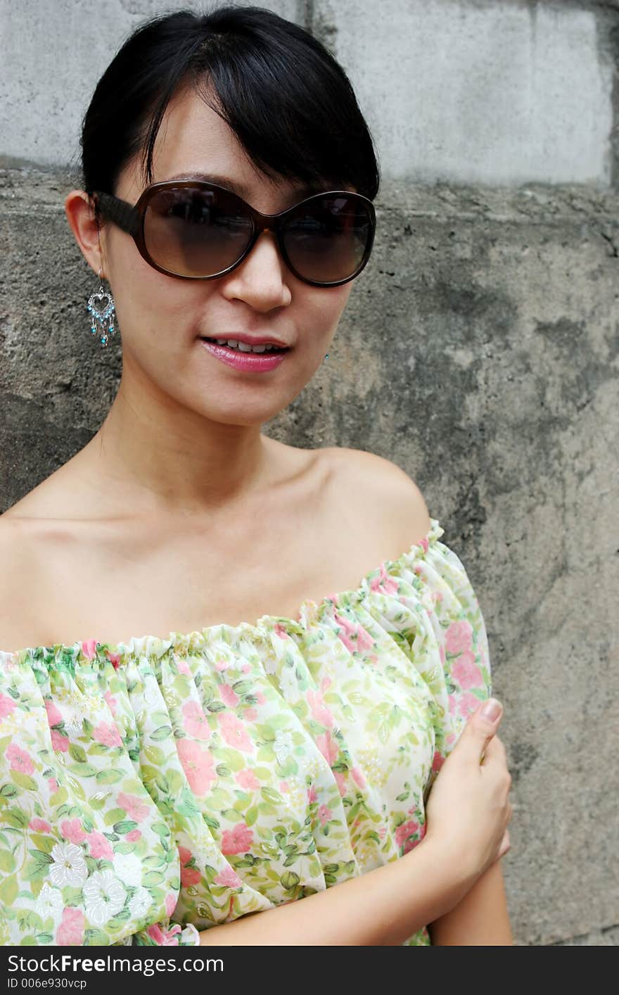 Portrait of a pretty Asian woman wearing big shades