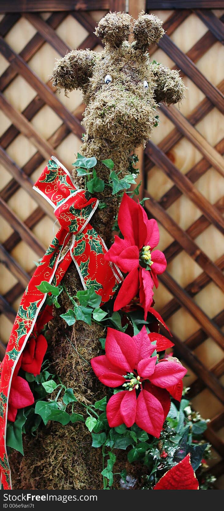 Christmas reindeer dressed in green moss and festive ribbons. Christmas reindeer dressed in green moss and festive ribbons