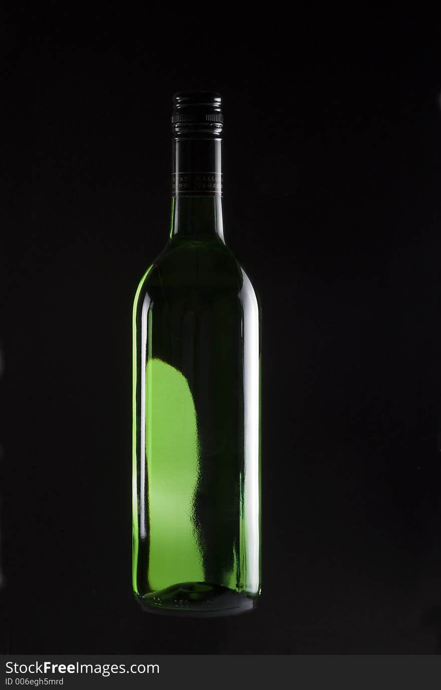 Wine Bottle backlit and isolated on black. Wine Bottle backlit and isolated on black