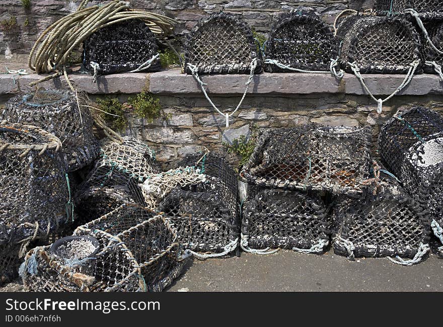 Lobster pots stacked on top of each other drying in the sun on the harbour at brixham torbay devon england europe uk taken in july 2006