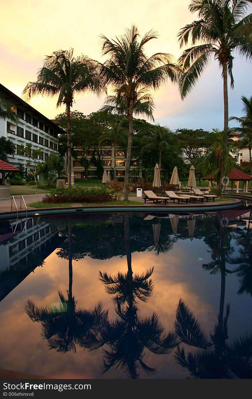 Evening at a city resort poolside. Evening at a city resort poolside