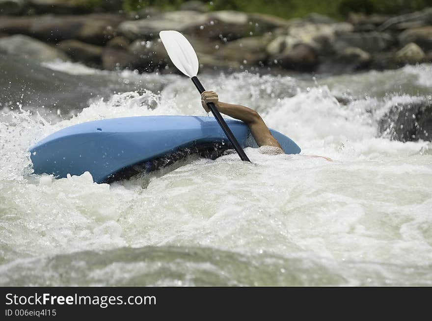 Adventurous Whitewater Kayaker in Rapids