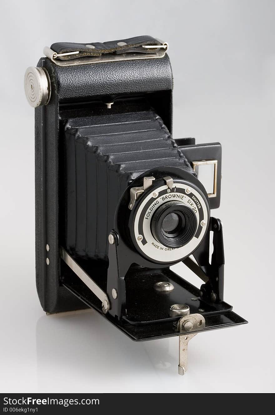 Old black photo camera on white