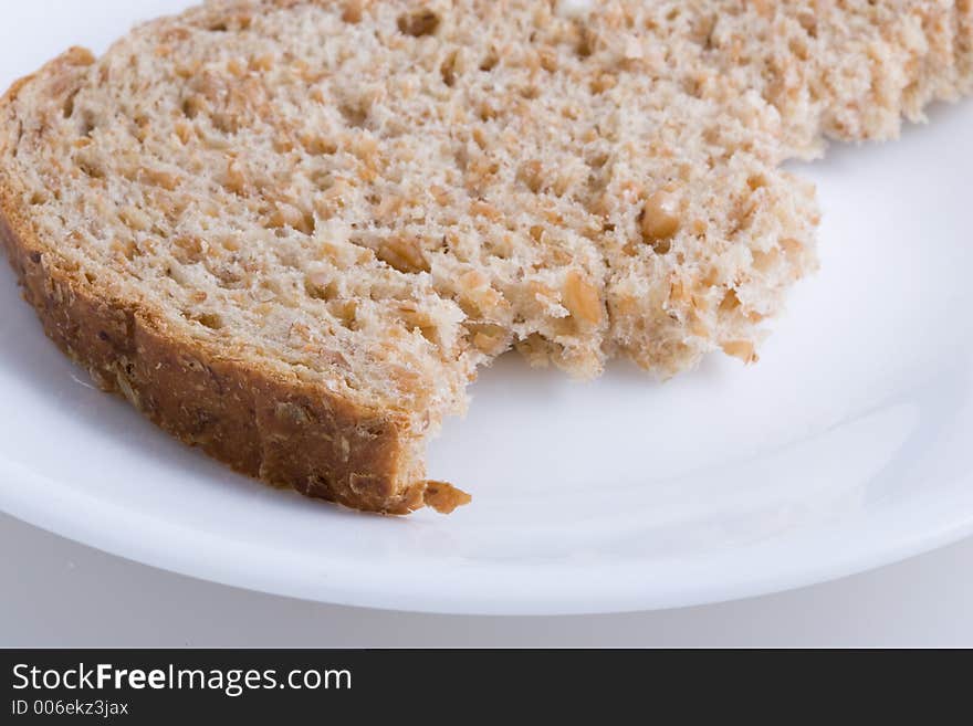 Piece of bread on white plate