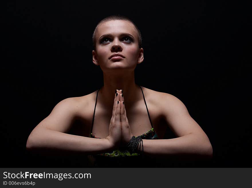 Bald girl praying and looking up