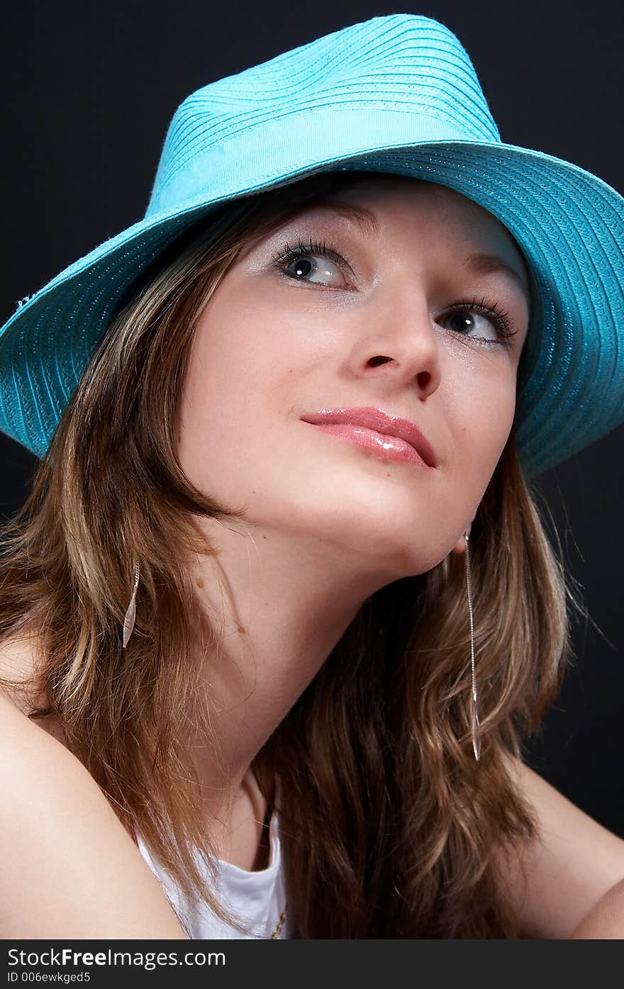 Young blonde girl with hat smiling, close-up. Young blonde girl with hat smiling, close-up