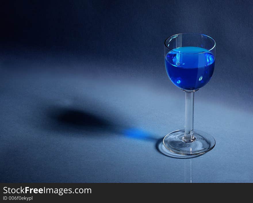 Liqueur glass on blue background