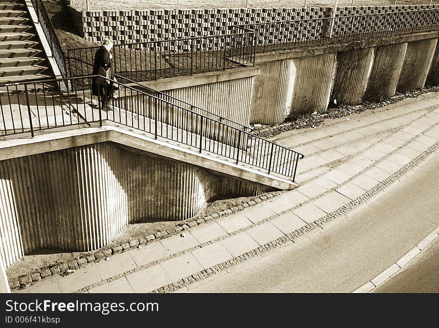 A street in denmark, shot from above (a bridge) ,a woman going down the staircases. A street in denmark, shot from above (a bridge) ,a woman going down the staircases