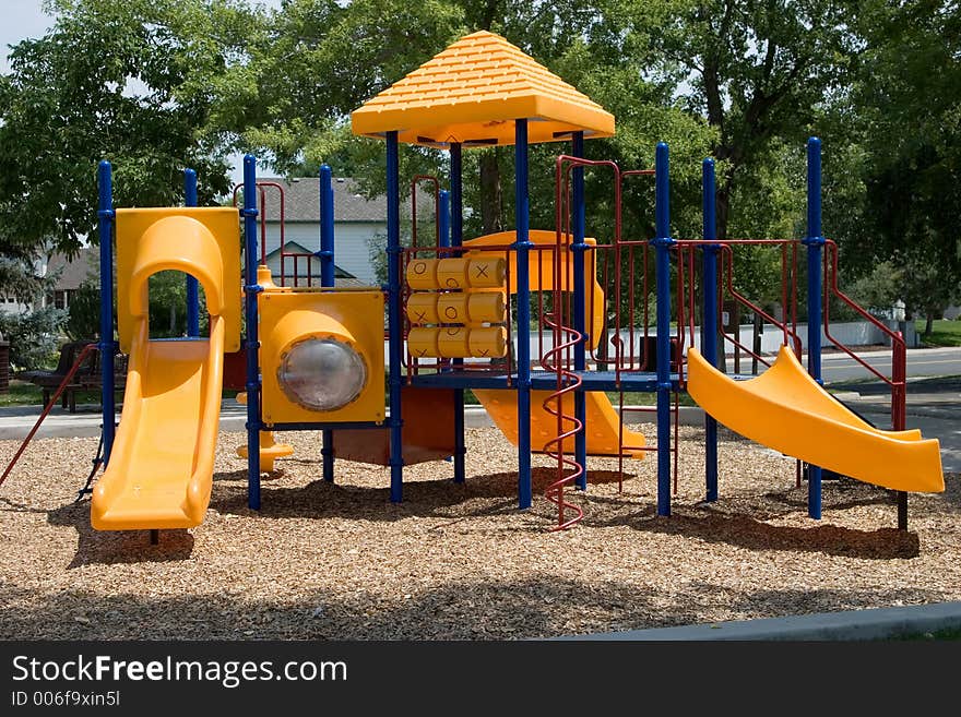 A playground built for young kids in primary colors of red, blue and yellow. A playground built for young kids in primary colors of red, blue and yellow.