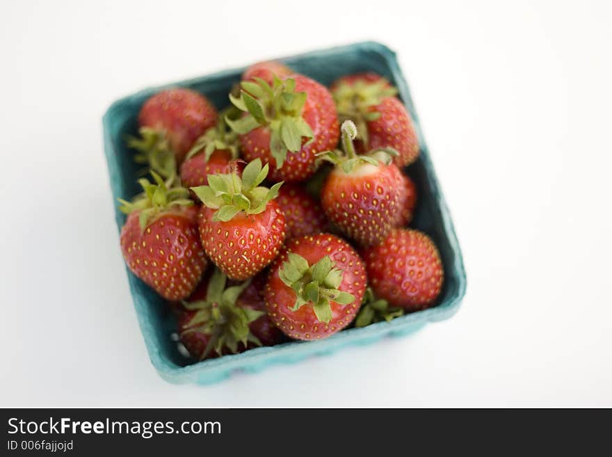 A quart of fresh strawberries from above.