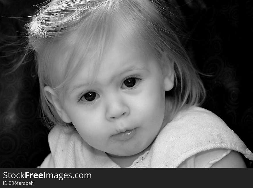 A baby with a serious expression on her face.