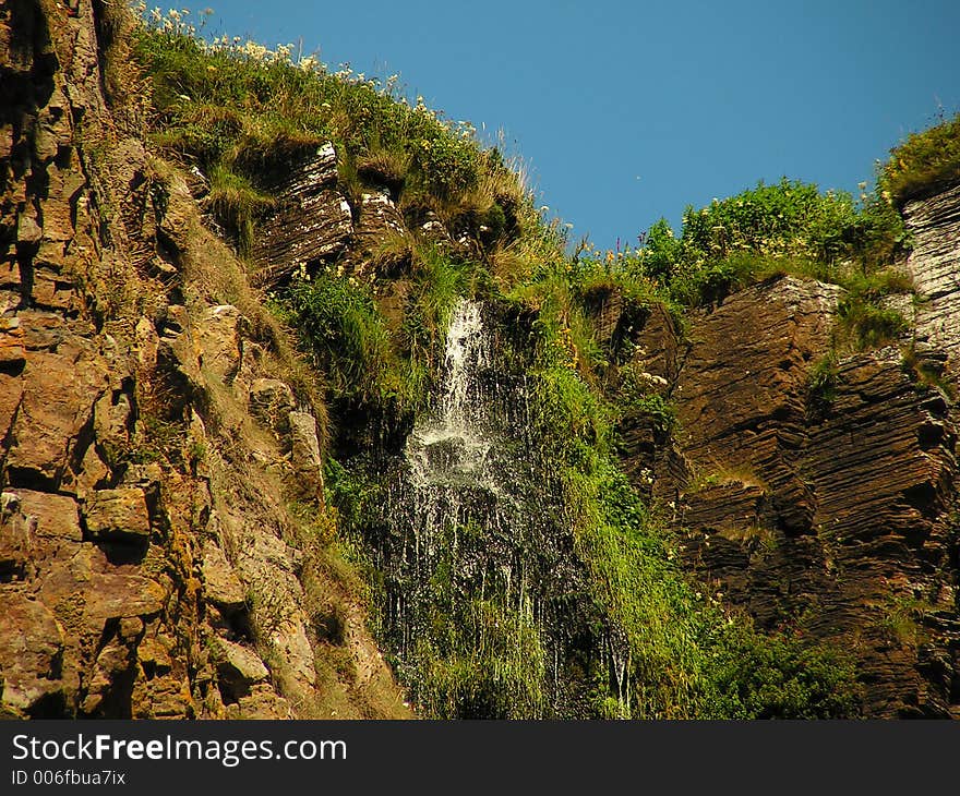 At the top of 150ft cliff, the water runs off into the sea. At the top of 150ft cliff, the water runs off into the sea.