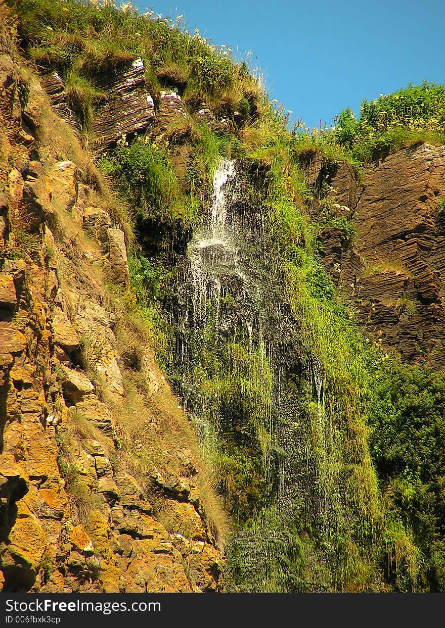 At the top of 150ft cliff, the water runs off into the sea. At the top of 150ft cliff, the water runs off into the sea.