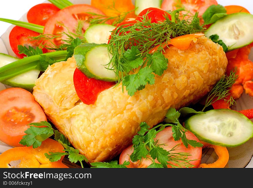 Appetizing meat pie with vegetables dish close-up