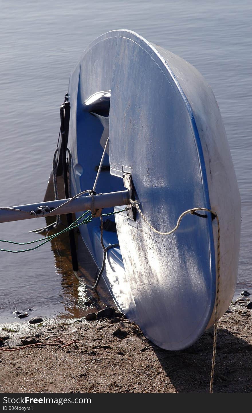 Laser class dinghy at waters edge. Laser class dinghy at waters edge