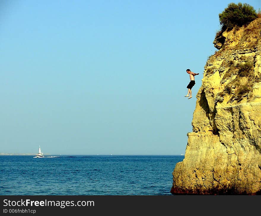 Swimmer in the Batata beach of the Potato in Algarve Lakes(Lagos) training of fast form divings for the sea. Swimmer in the Batata beach of the Potato in Algarve Lakes(Lagos) training of fast form divings for the sea.