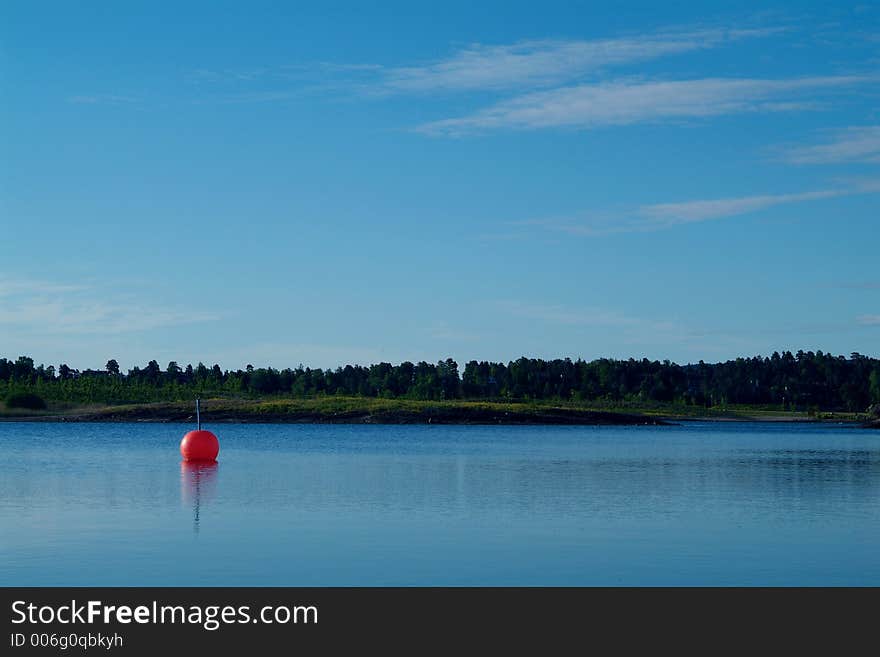 Orange buoy in calm waters