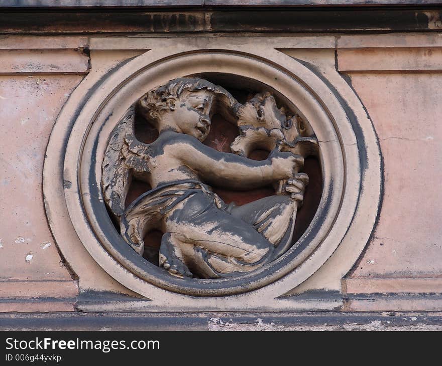 Sculptured motif of child holding branch