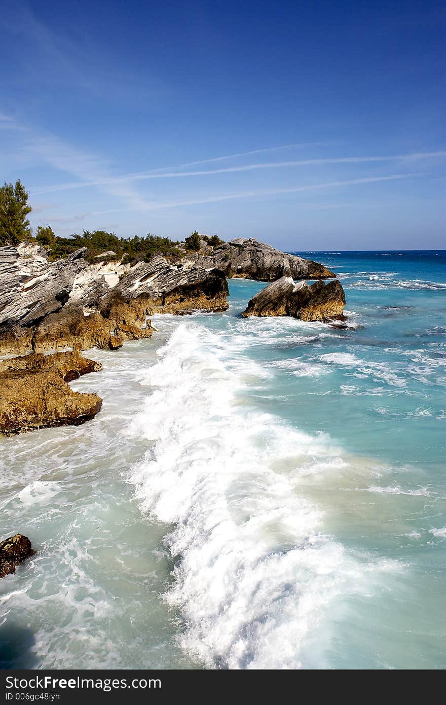 A tropical coast line with large crashing waves. A tropical coast line with large crashing waves