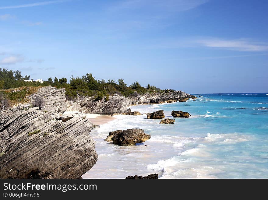 A tropical coast line with large crashing waves. A tropical coast line with large crashing waves