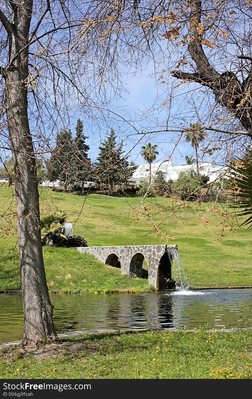 Waterfall from man made bridge into lake