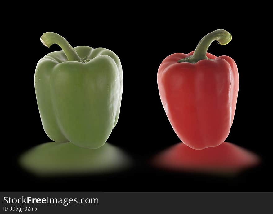 Red and green pepper isolated on black