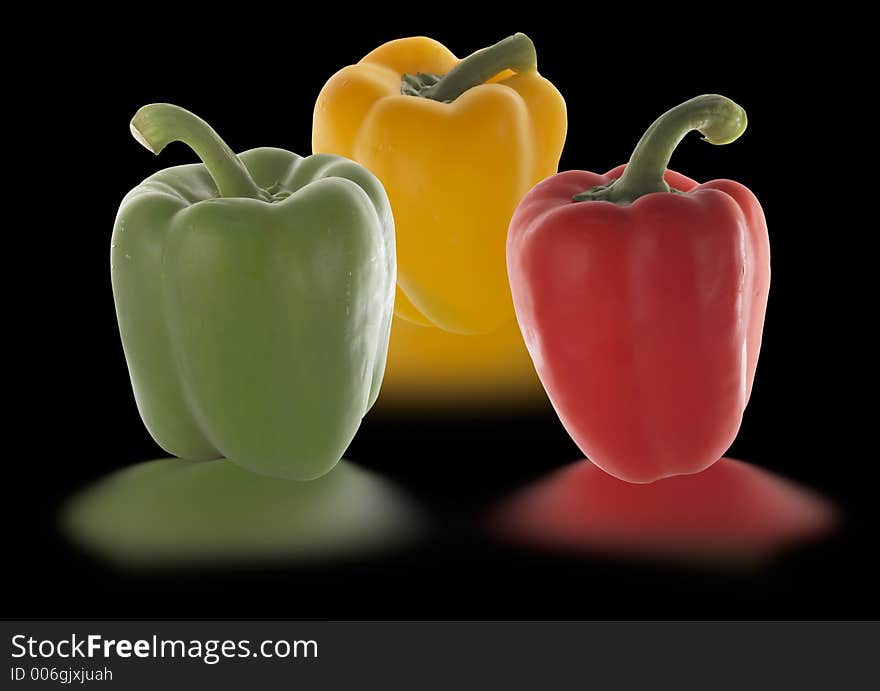 Peppers in different colors isolated on black