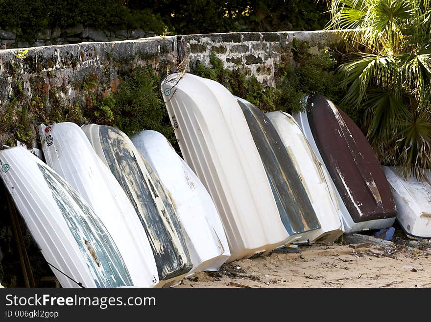 A bunch of small boats in the sand. A bunch of small boats in the sand