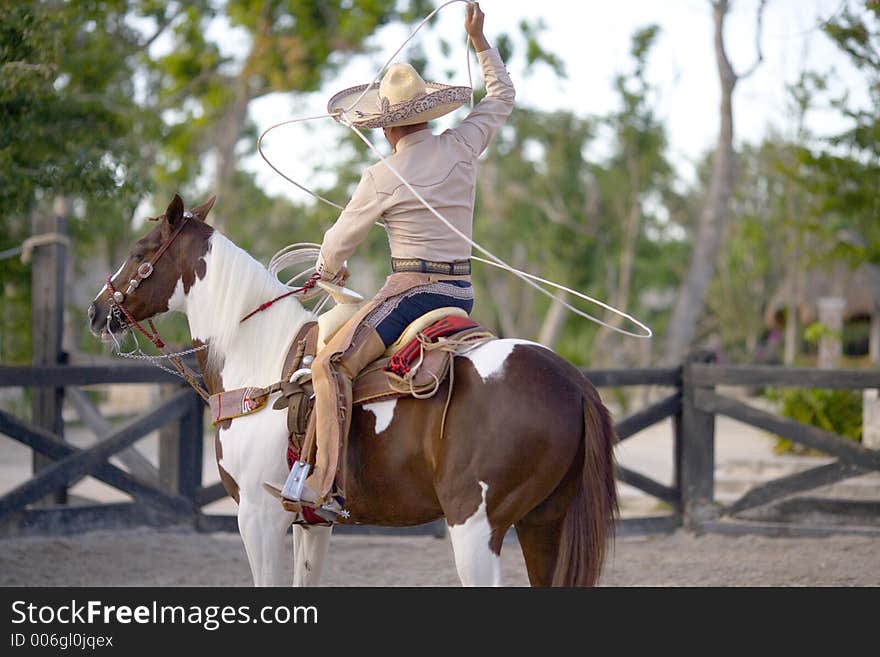 Man on horse back hunting on other horse